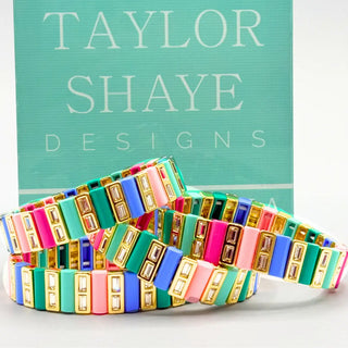 Preppy shades of pink, green and blue bars alternating with gold and faux diamond gemstones.  Stretch bracelet that makes a statement.  Found at Southern Quirks gifts and goods.