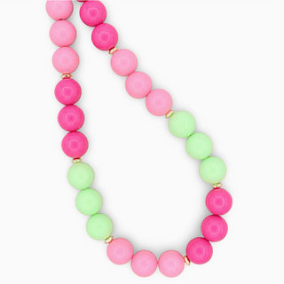 Necklace with pink and green beads on a white background