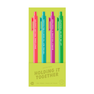 A set of four colorful gel pens in a lime green packaging box. The pens are pink, teal, purple, and green, each with white text on the barrel and a matching colored clip. Southern Quirks Gifts & Goods