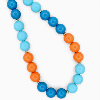 Necklace with blue and orange beads on a white background