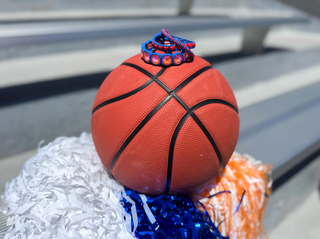 Basketball with pom-poms on a bleacher