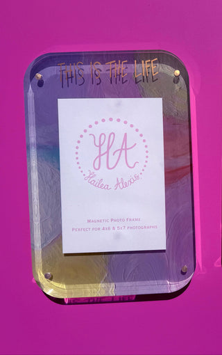 Acrylic magnetic photo frame with custom gold metallic This is the Life text and monogram inserts, displayed side-by-side against a vibrant magenta background.  At Southern Quirks Gifts & Goods in Edmond, OK.